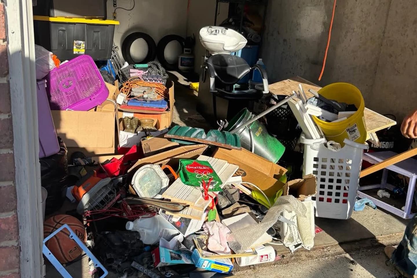 Garage entrance blocked by household items before cleanout