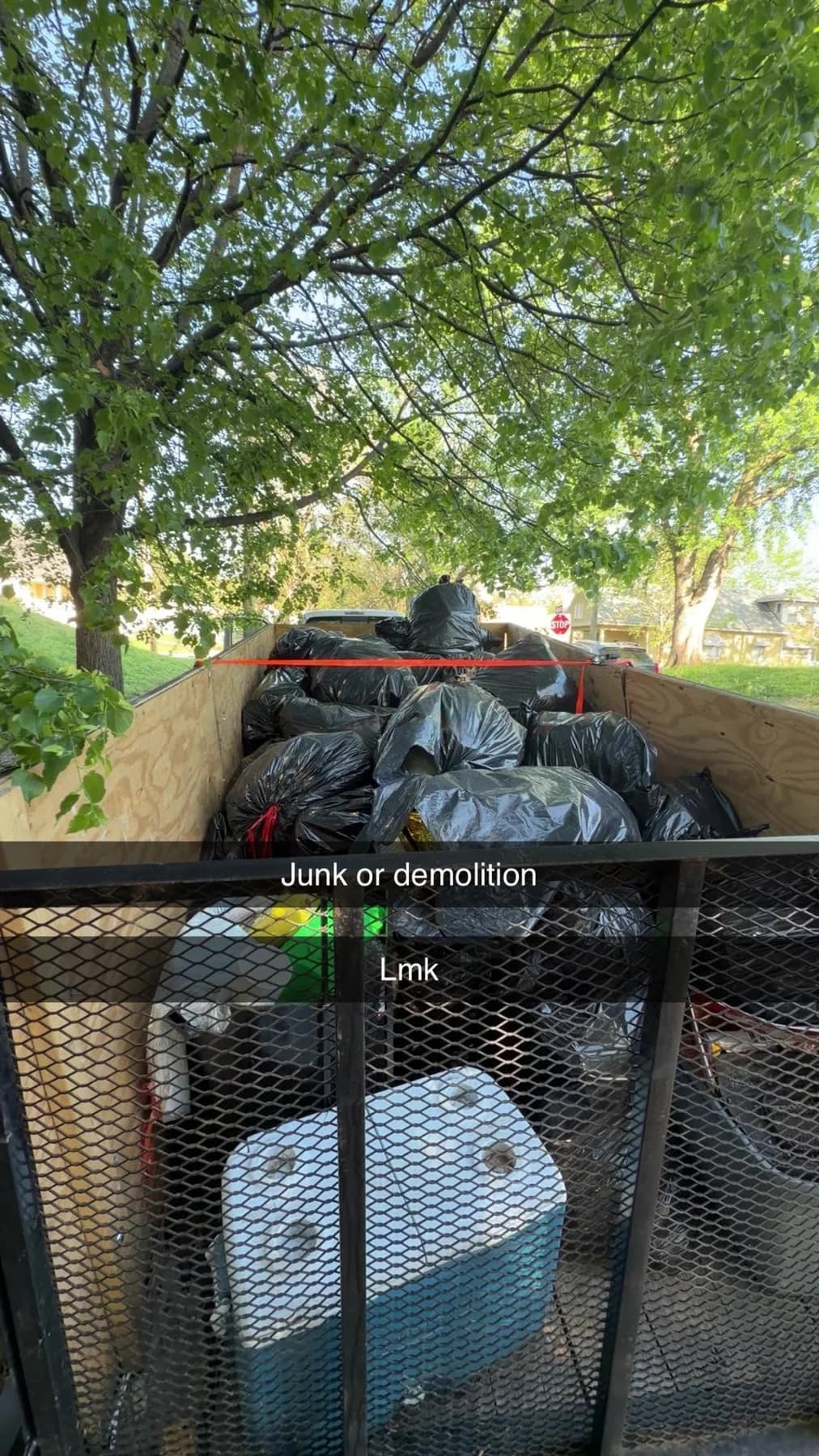 Trailer loaded with yard waste and removal material