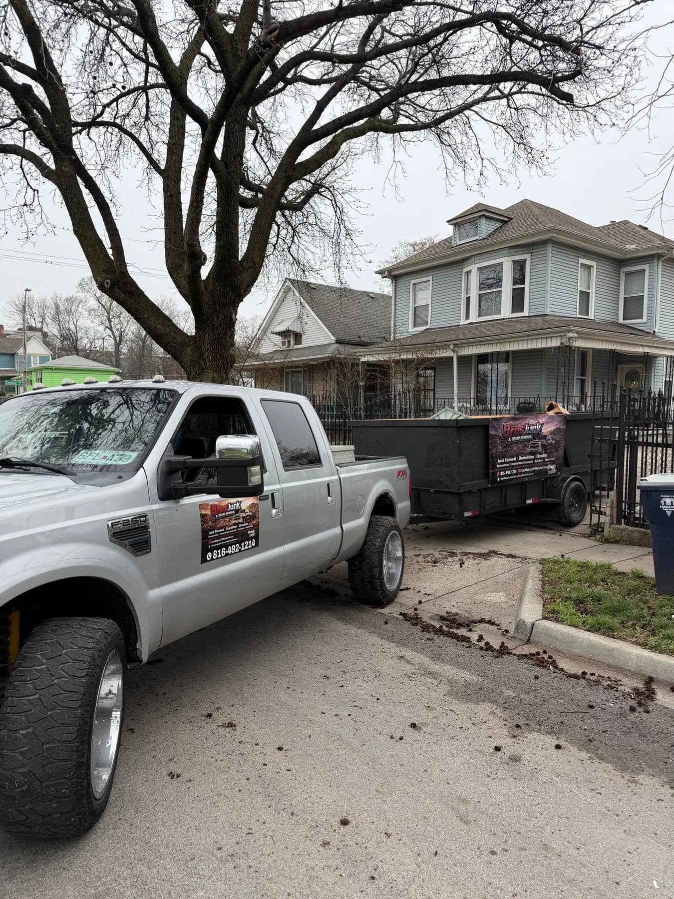 Bros Junk truck and trailer at a Kansas City property